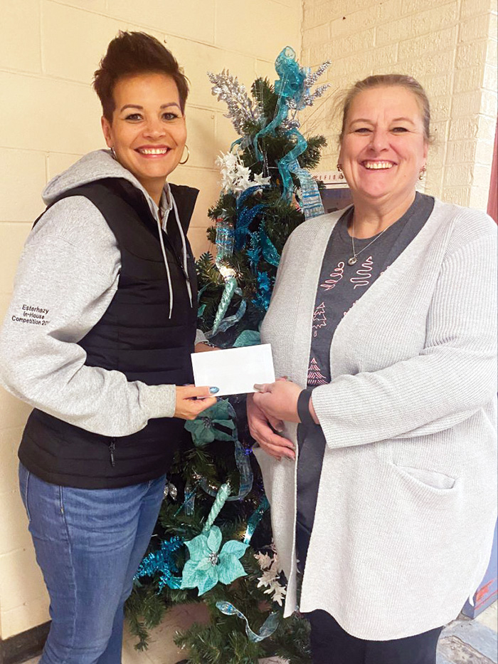 Funds and gifts from the Esterhazy Teams holiday celebrations were donated to three local food banks in Esterhazy, Langenburg and Churchbridge. Left is Raelene Andres, Sr. Administrative Assistant  Esterhazy, presenting a check to Lynette Griffith with Esterhazy and Area Hampers. <br />
